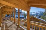 Enjoy breathtaking mountain views from this stunning chalet balcony.