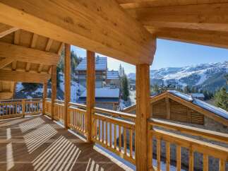 Enjoy breathtaking mountain views from this stunning chalet balcony.
