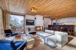 Experience luxury living in this stunning chalet, featuring a cozy fireplace and breathtaking mountain views.