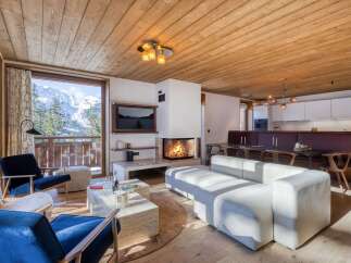 Experience luxury living in this stunning chalet, featuring a cozy fireplace and breathtaking mountain views.