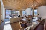 Experience luxury living in this stunning property, featuring a cozy fireplace and a modern dining area.