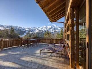 Experience the ultimate in luxury living with this stunning property featuring a spacious deck with breathtaking mountain views.