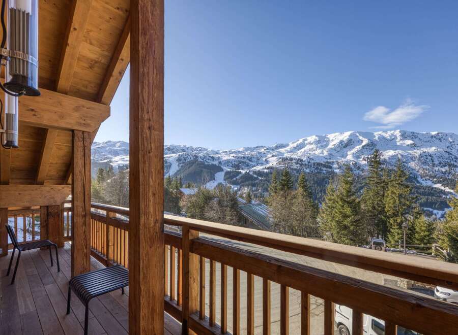 Enjoy breathtaking mountain views from this stunning chalet balcony.