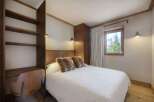 This cozy bedroom features a comfortable bed with fluffy pillows, perfect for a relaxing stay.