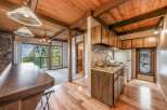 Discover the charm of this cozy cabin with its rustic wooden ceiling and inviting ambiance.
