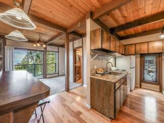 Discover the charm of this cozy cabin with its rustic wooden ceiling and inviting ambiance.
