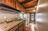 Step into this charming kitchen, featuring warm wooden cabinetry and a stunning granite countertop.