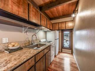 Step into this charming kitchen, featuring warm wooden cabinetry and a stunning granite countertop.