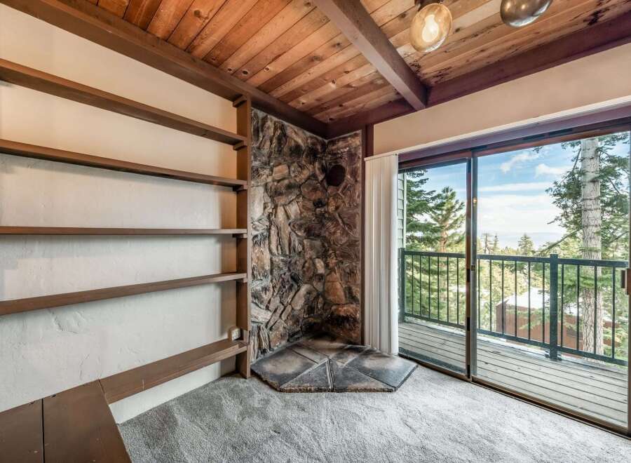 Discover the charm of this cozy retreat, featuring a stunning stone fireplace and built-in shelving, perfect for displaying your favorite decor.