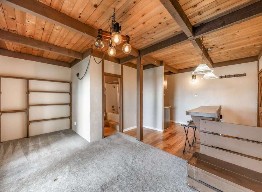 Step into this unique property featuring a stunning wooden ceiling with exposed beams, creating a warm and inviting atmosphere.