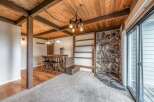 Step into this charming space featuring a rustic stone fireplace and a cozy bar area, perfect for entertaining.