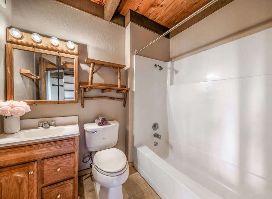 Step into this charming bathroom featuring rustic wooden accents and a cozy atmosphere.