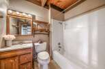 Step into this charming bathroom featuring rustic wooden accents and a cozy atmosphere.