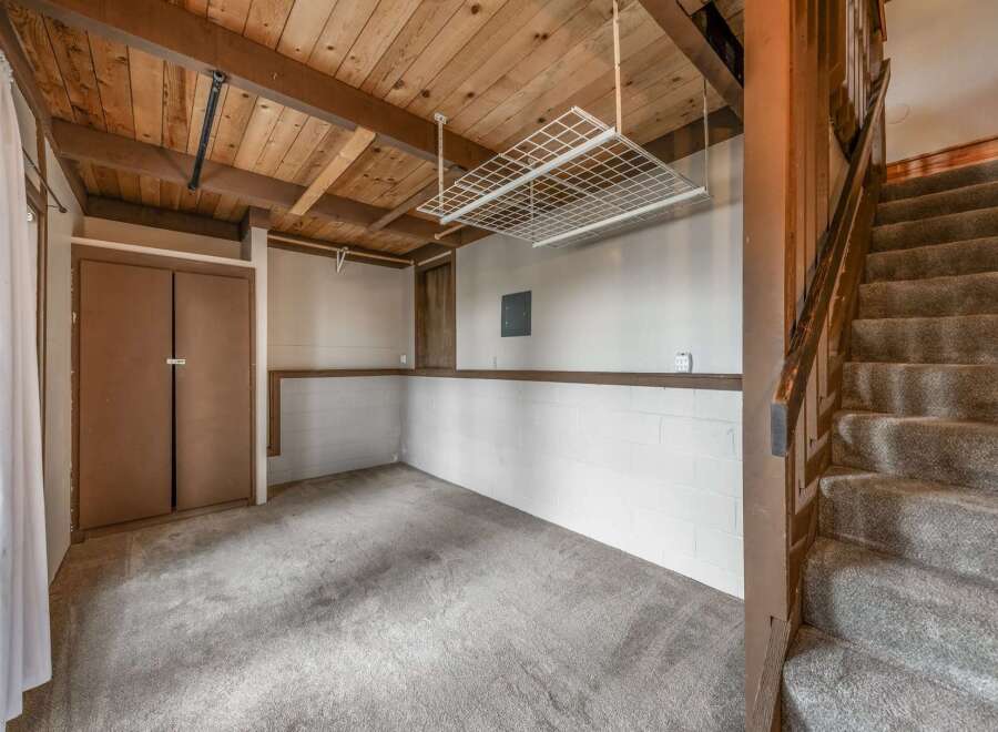Discover the potential of this versatile space! This room features a unique wooden ceiling, adding warmth and character.