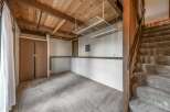 Discover the potential of this versatile space! This room features a unique wooden ceiling, adding warmth and character.