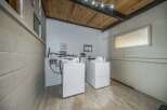 This laundry room features two washing machines and a dryer, perfect for convenient in-unit laundry.