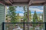 Enjoy breathtaking views from this stunning property! This home offers a serene escape with a balcony overlooking a picturesque landscape of snow-covered trees and distant buildings.