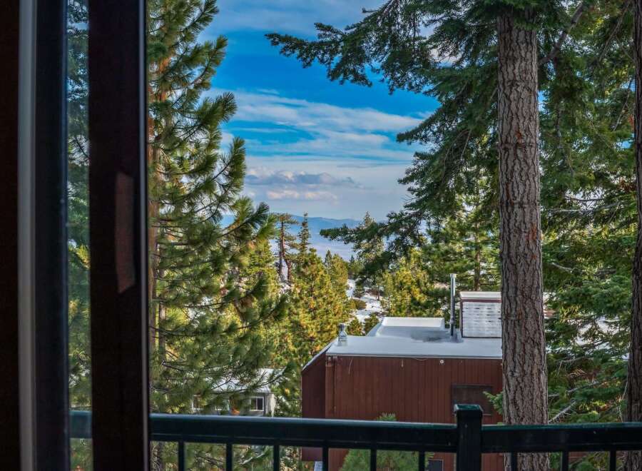 Enjoy breathtaking views from this stunning property! This home offers a serene escape with its picturesque surroundings, including lush trees and a glimpse of the mountains.