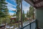Enjoy breathtaking views from this stunning property, nestled amidst towering trees and a serene winter landscape.