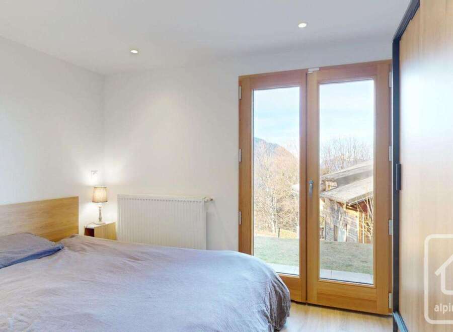 This stunning bedroom features a serene ambiance with its neutral color palette and natural light.