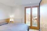 This stunning bedroom features a serene ambiance with its neutral color palette and natural light.