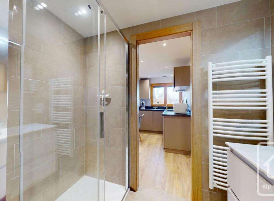 Step into luxury with this stunning property featuring a modern shower and a well-equipped kitchen.