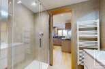 Step into luxury with this stunning property featuring a modern shower and a well-equipped kitchen.