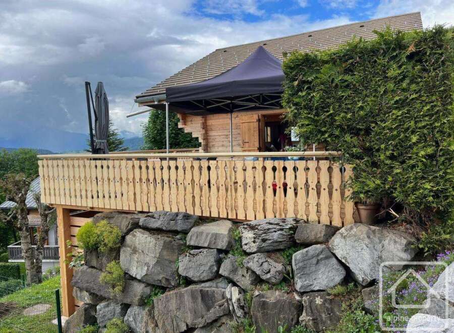 Discover a charming property nestled in a picturesque setting, featuring a beautifully crafted wooden balcony.