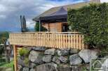 Discover a charming property nestled in a picturesque setting, featuring a beautifully crafted wooden balcony.