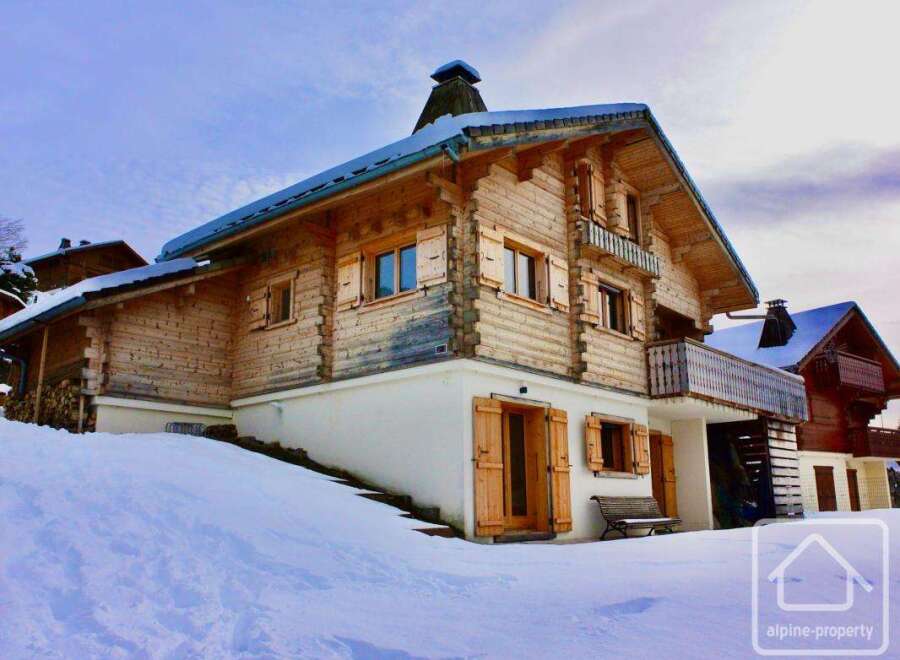 Discover a stunning chalet nestled in a snowy landscape, perfect for a winter getaway.