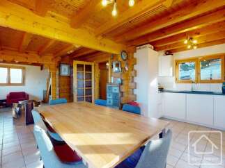 Experience the charm of this stunning property, featuring a spacious dining area with a large wooden table, perfect for gatherings.