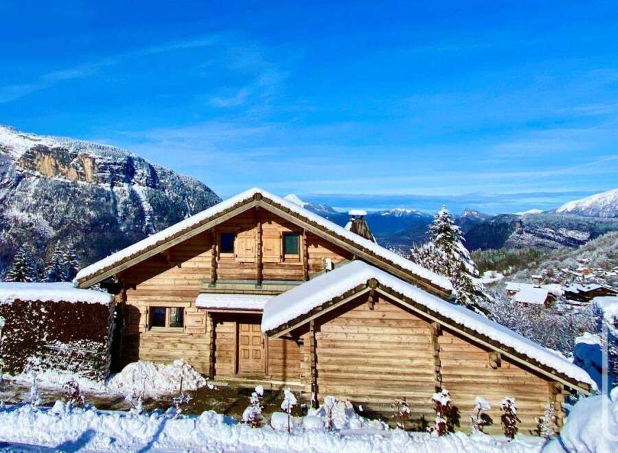 Discover the charm of this stunning wooden chalet nestled in a picturesque winter wonderland.