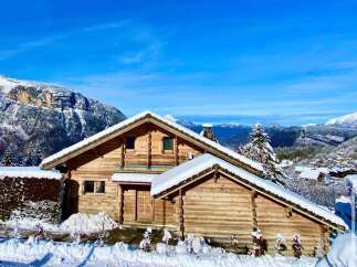 Discover the charm of this stunning wooden chalet nestled in a picturesque winter wonderland.