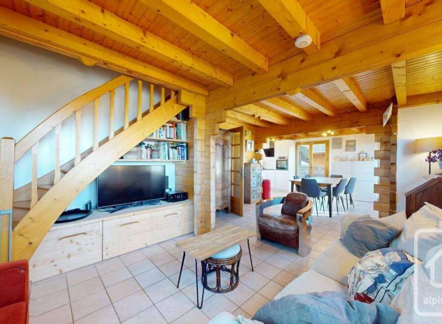 Discover the charm of this stunning property, featuring a warm and inviting interior with exposed wooden beams and a cozy ambiance.