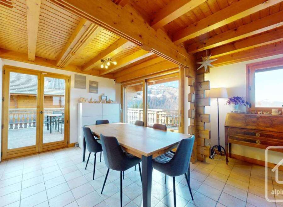 Discover the charm of this stunning property, featuring a spacious dining area with a wooden table and comfortable seating.