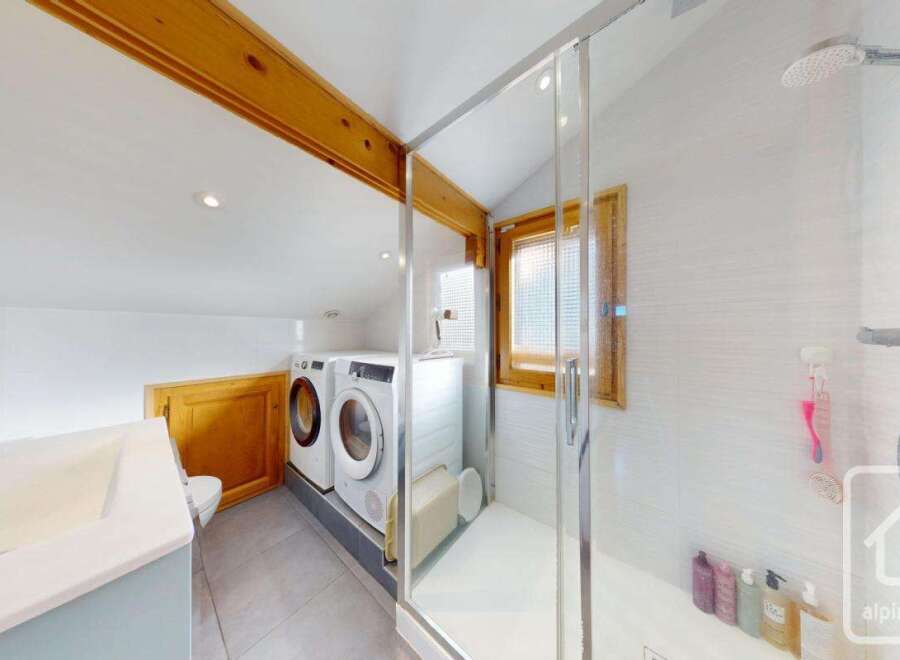 This stunning property boasts a modern bathroom with a sleek shower and a convenient laundry area.