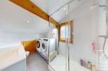 This stunning property boasts a modern bathroom with a sleek shower and a convenient laundry area.