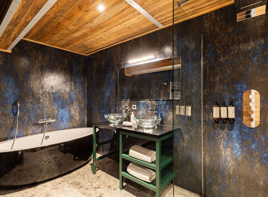 This luxurious bathroom boasts a stunning design with a unique blend of textures and colors.