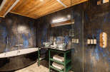 This luxurious bathroom boasts a stunning design with a unique blend of textures and colors.