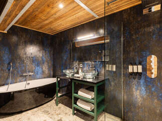 This luxurious bathroom boasts a stunning design with a unique blend of textures and colors.