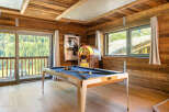 Experience luxury living in this stunning property featuring a game room with a pool table and a vintage jukebox.