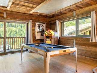 Experience luxury living in this stunning property featuring a game room with a pool table and a vintage jukebox.