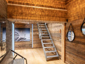 Step into luxury with this stunning property featuring exquisite wooden accents and a unique design.