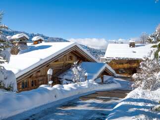Nestled in a picturesque winter wonderland, this charming property boasts traditional wooden architecture and snow-covered roofs.