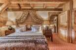 Step into a cozy bedroom retreat, where rustic charm meets elegant design.