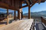Enjoy breathtaking mountain views from this stunning chalet's expansive deck.