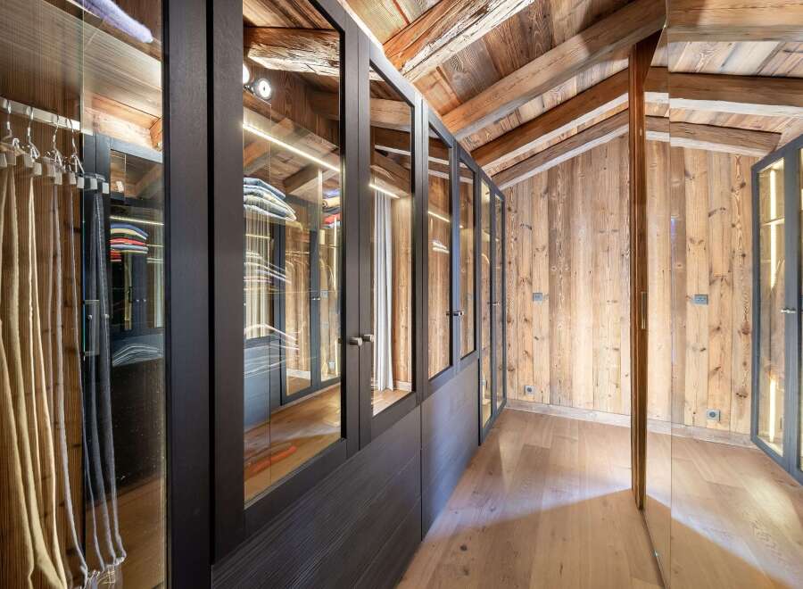 Step into luxury with this stunning walk-in closet, featuring custom cabinetry and ample storage space.