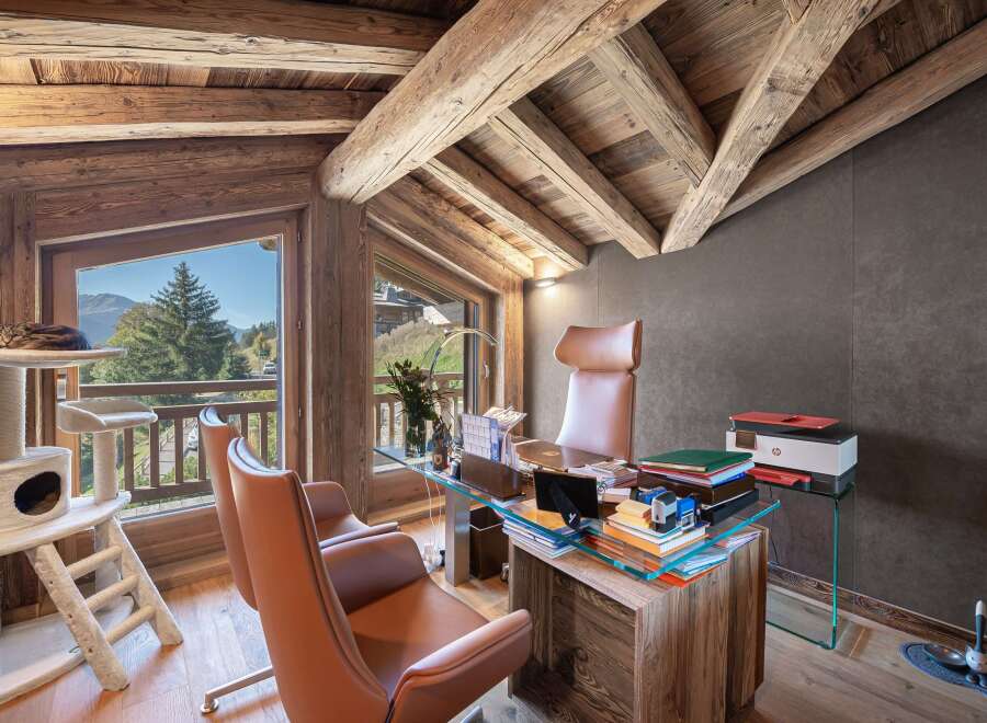 This stunning office space boasts a rustic charm with its exposed wooden beams and natural light.