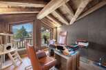 This stunning office space boasts a rustic charm with its exposed wooden beams and natural light.