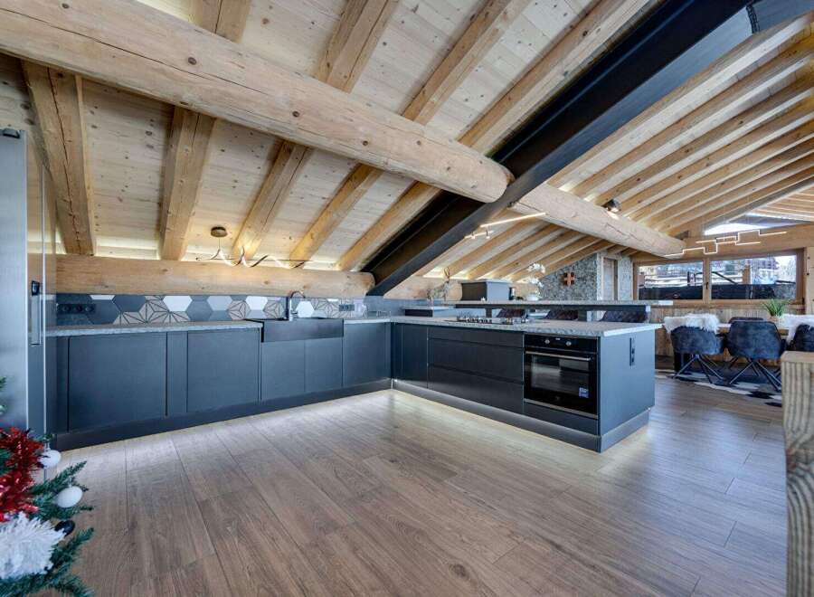 Experience luxury living in this stunning property featuring a modern kitchen with sleek cabinetry and high-end appliances.